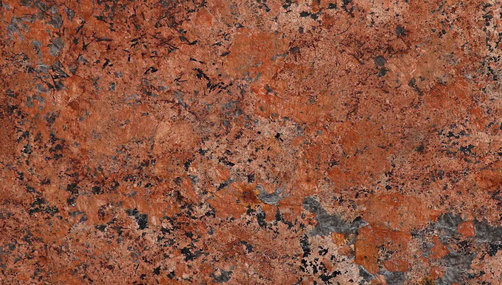Alaska Red Granite slab &mdash; medium red to brick-red with scattered quartz inclusions