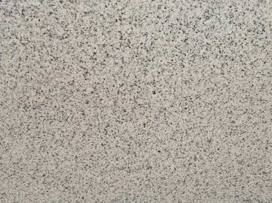 China White Granite slab &mdash; bright white with fine grey and black mineral speckles
