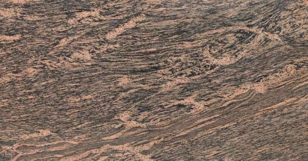 Tiger Skin Granite slab &mdash; golden-amber with distinctive dark flowing stripe patterns